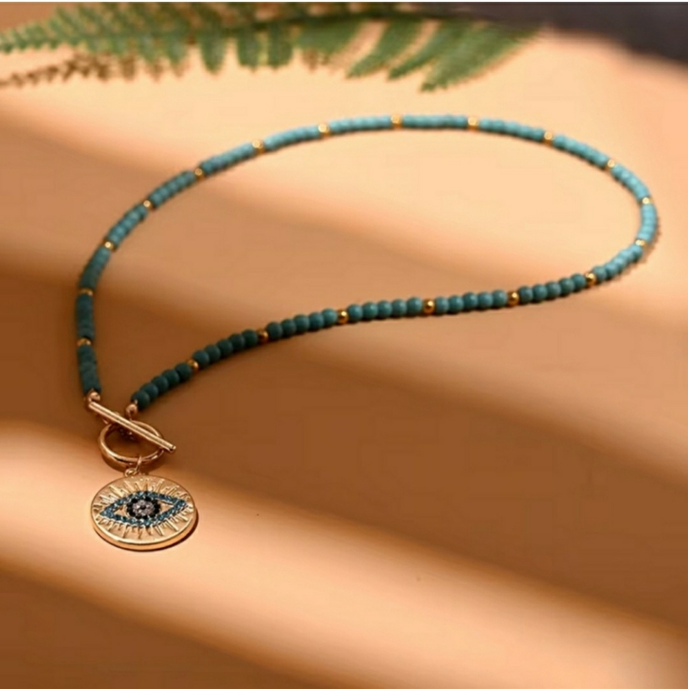 Elegant Beaded Necklace with Eye Pendant